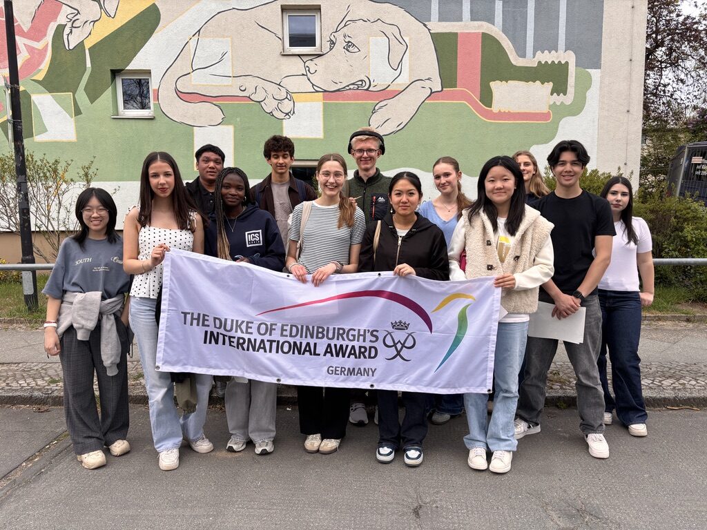 Youth Ambassadors 26-27 group with banner